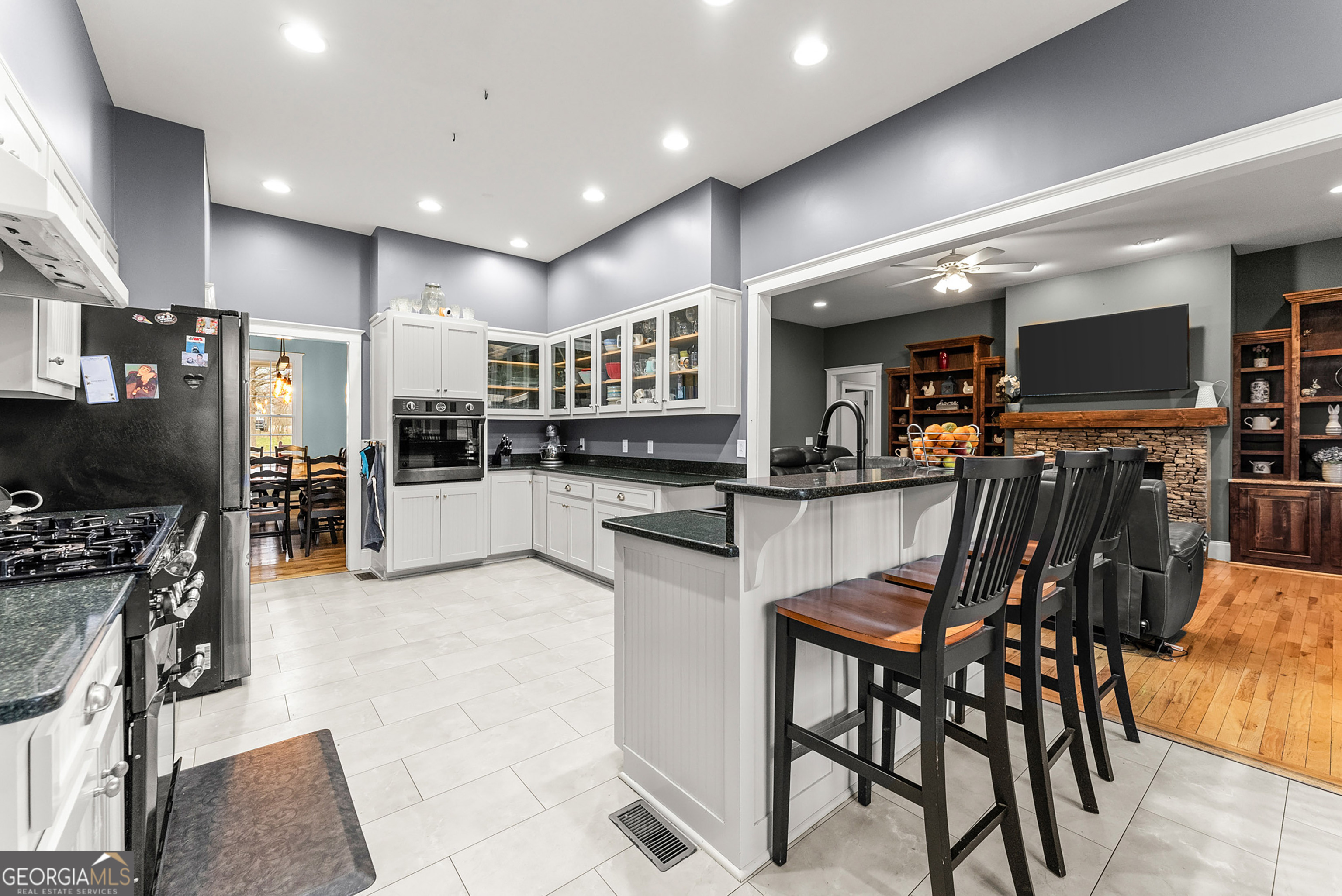 1295 Wall Bridge Loop Clarkesville, GA 30523 - Photo 21 of 76 a kitchen with stainless steel appliances kitchen island granite countertop a refrigerator and cabinets