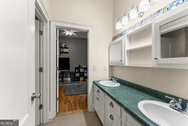 a bedroom with a bed and ceiling fan