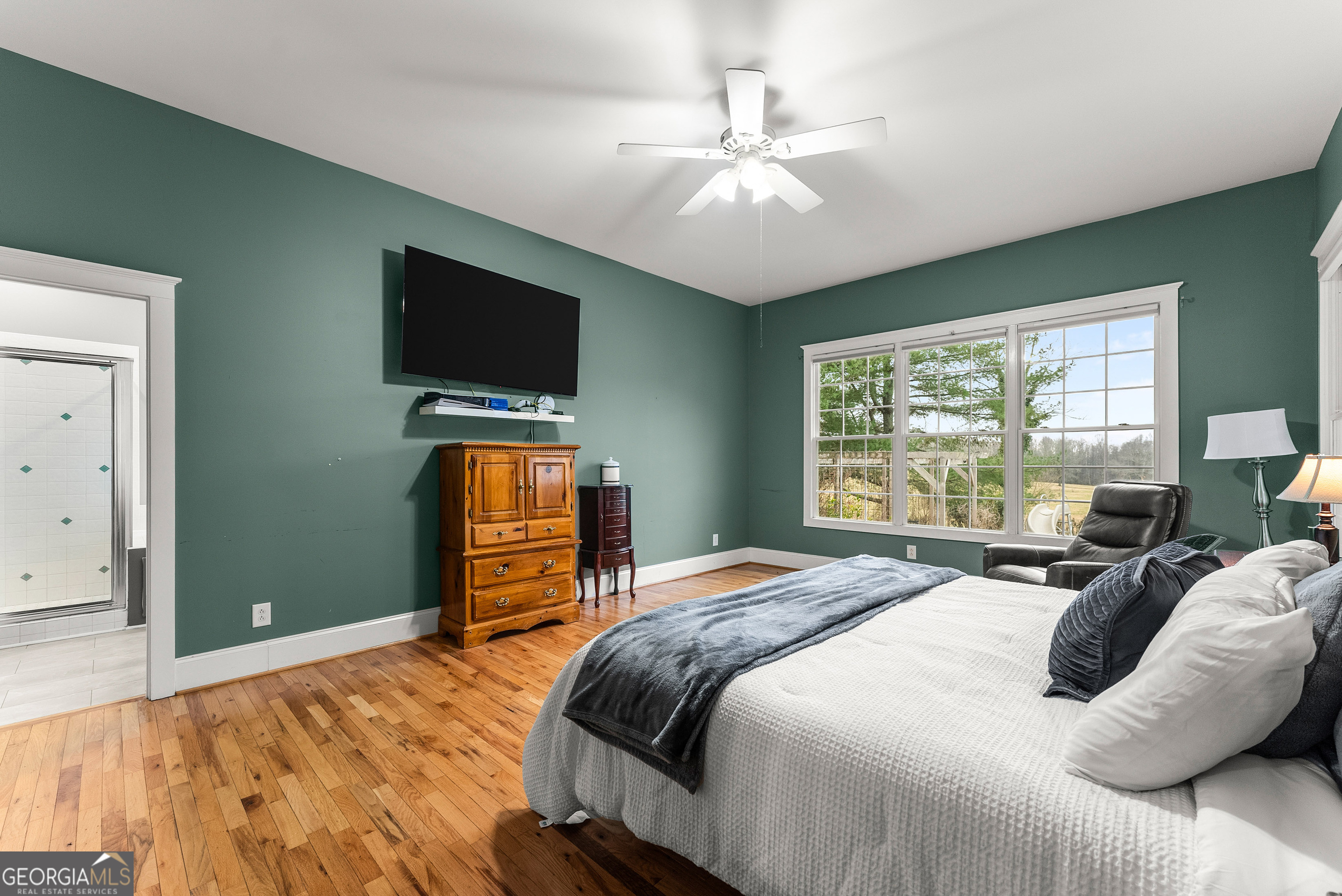 1295 Wall Bridge Loop Clarkesville, GA 30523 - Photo 38 of 76 a bedroom with a bed and a flat screen tv