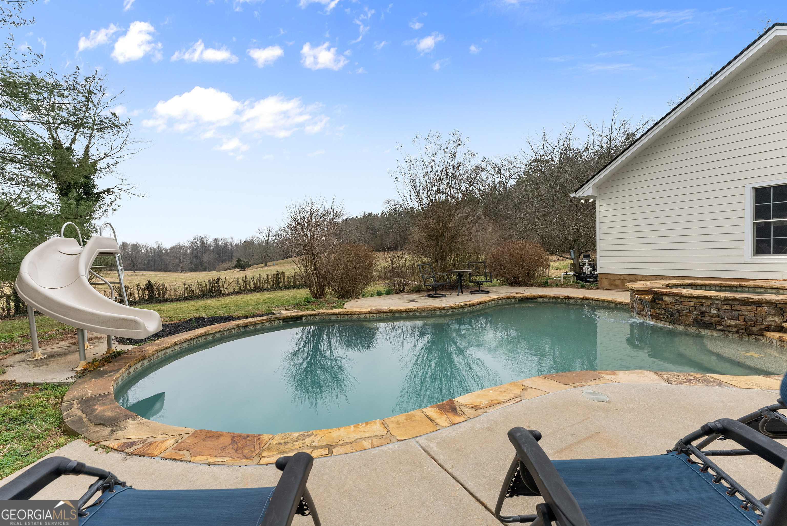 1295 Wall Bridge Loop Clarkesville, GA 30523 - Photo 60 of 76 a view of a swimming pool with a lounge chair