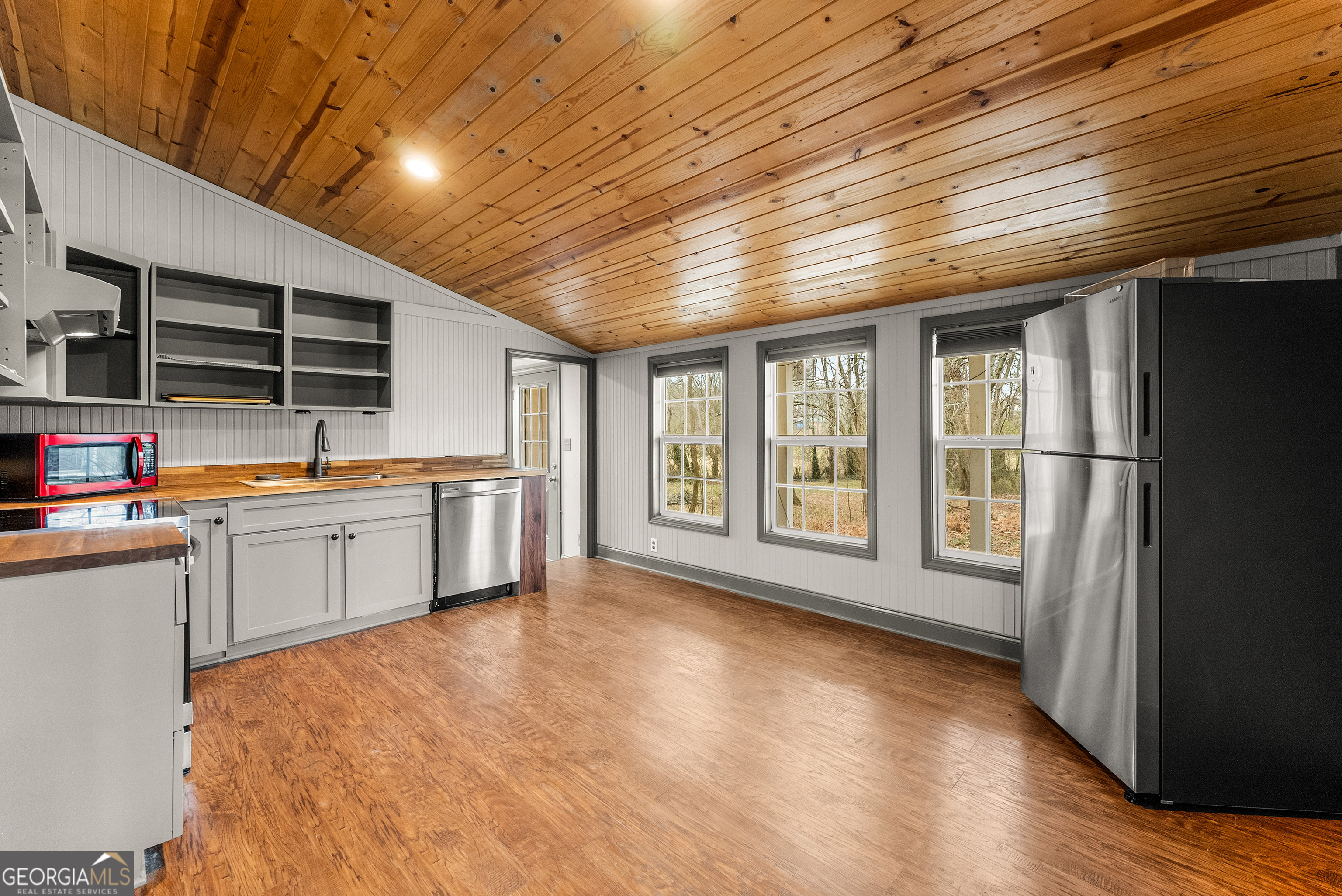 1295 Wall Bridge Loop Clarkesville, GA 30523 - Photo 65 of 76 a large white kitchen with stainless steel appliances granite countertop a stove and a refrigerator