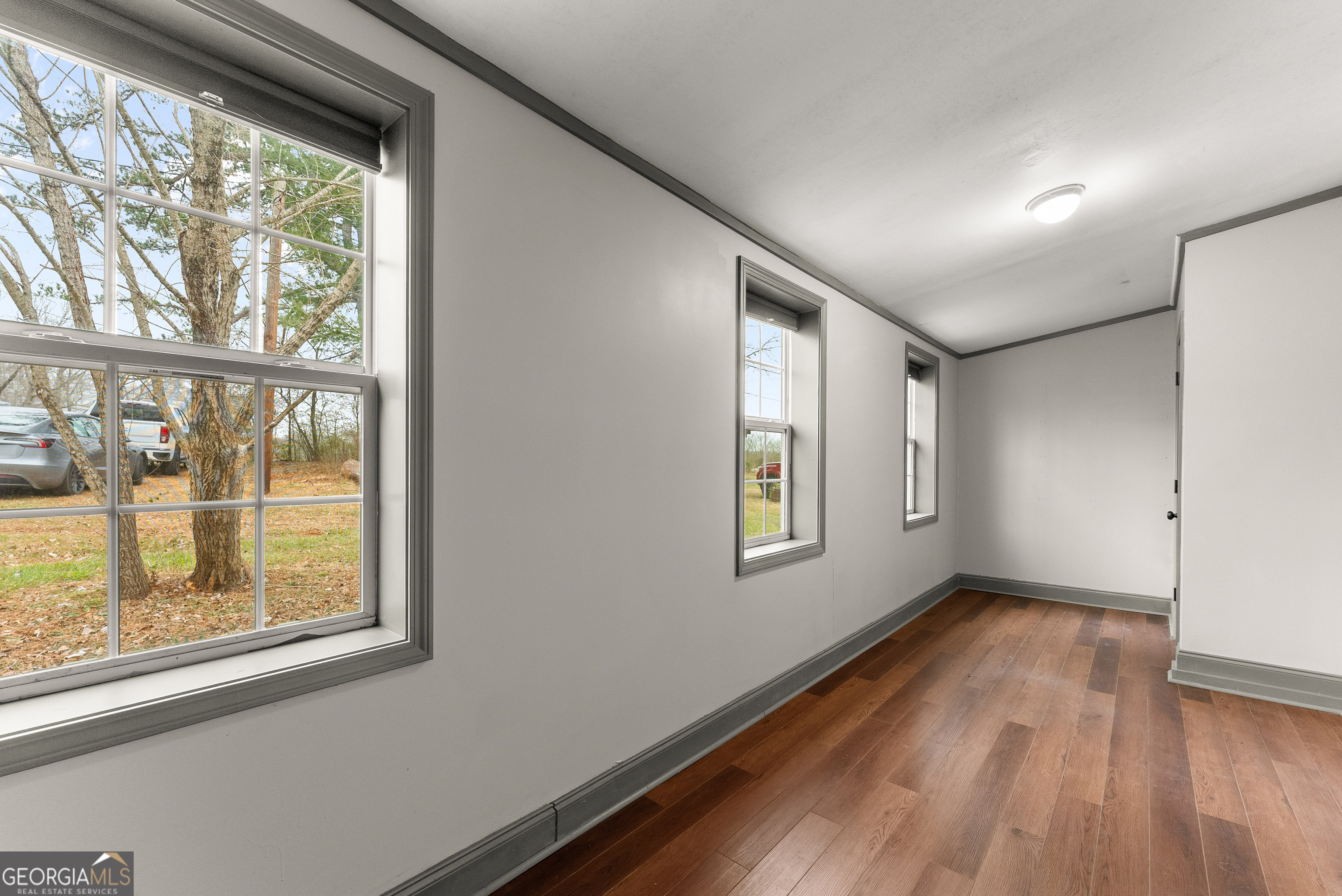 1295 Wall Bridge Loop Clarkesville, GA 30523 - Photo 73 of 76 a view of an empty room with a window and wooden floor