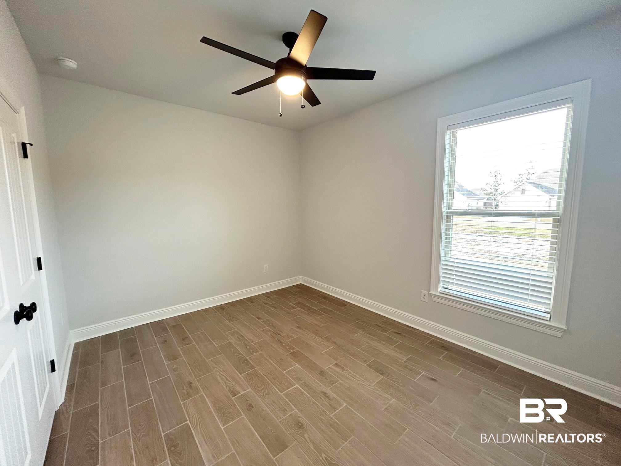 809 Sumter Loop Foley, AL 36535 - Photo 13 of 20 Empty room featuring ceiling fan and light wood-type flooring