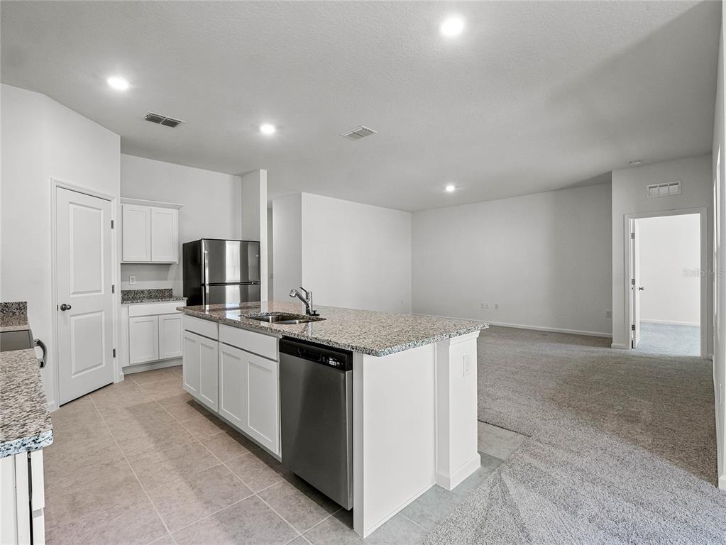 2202 Raven Rdg Road Clermont, FL 34715 - Photo 11 of 37 a kitchen that has a lot of cabinets in it and stainless steel appliances