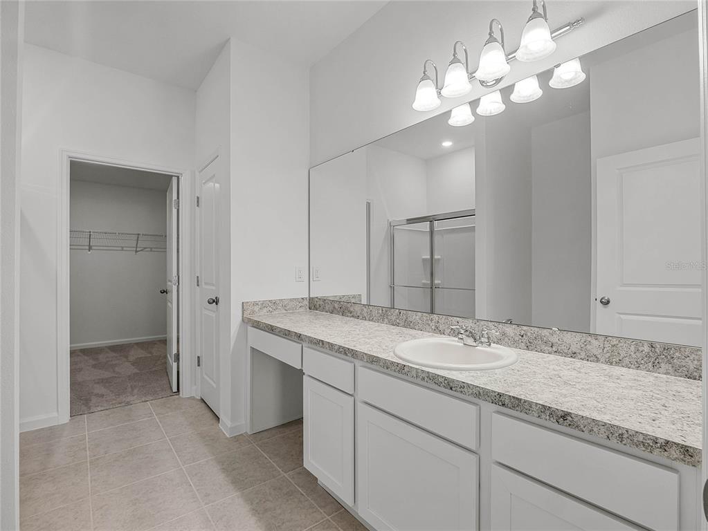 2202 Raven Rdg Road Clermont, FL 34715 - Photo 19 of 37 a bathroom with a double vanity sink and a mirror