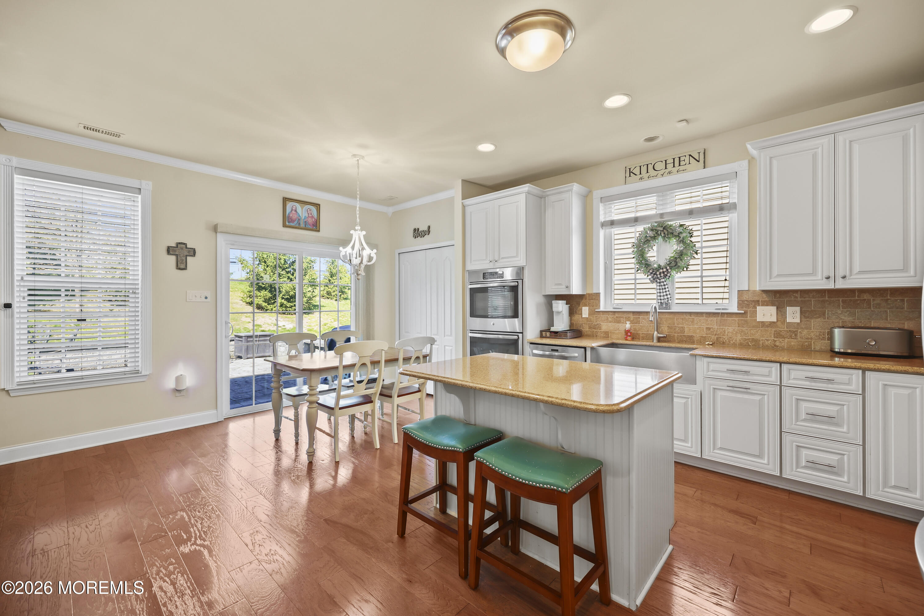 51 Mason Drive Jackson, NJ 08527 - Photo 13 of 39 a kitchen with a table chairs stove and cabinets