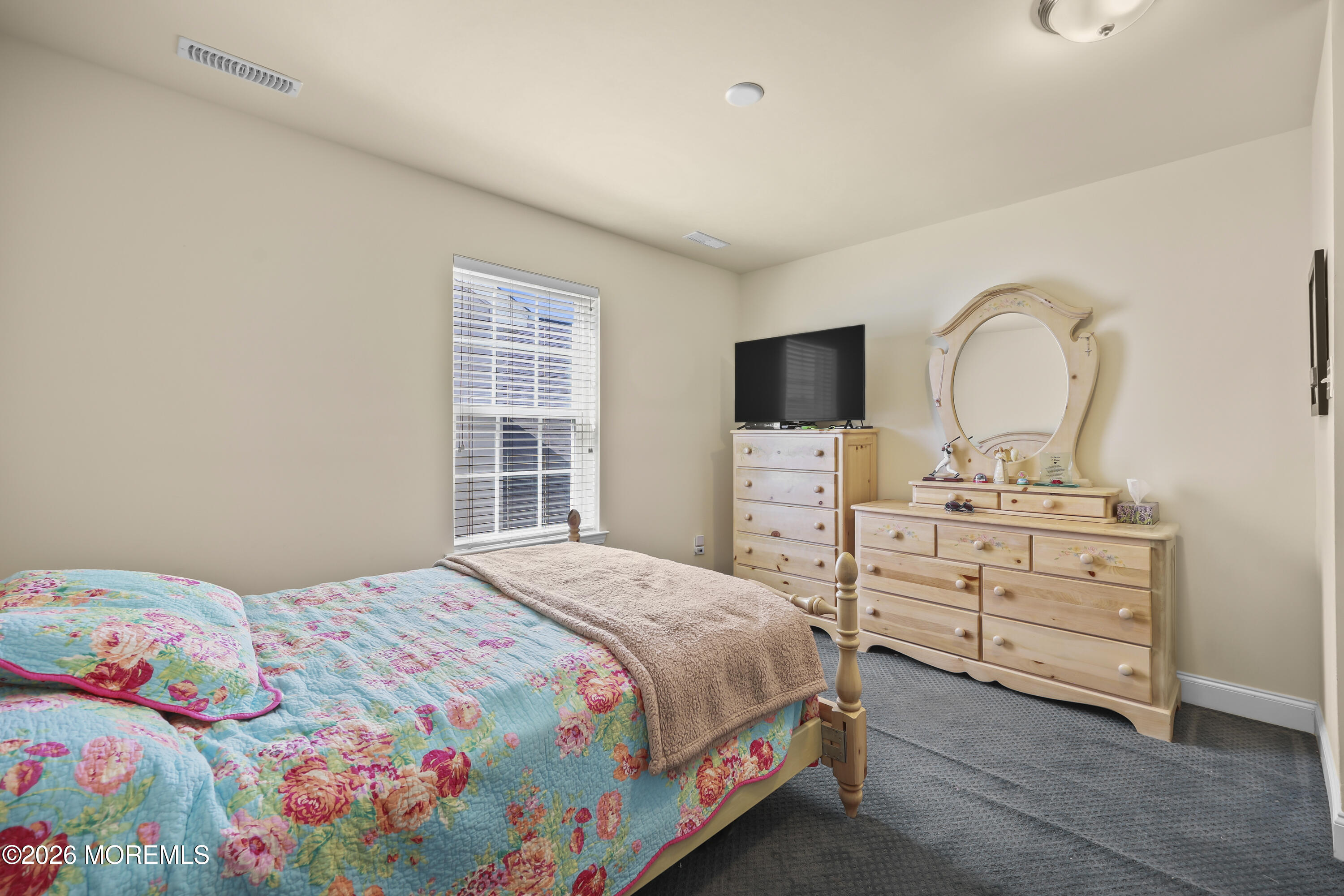 51 Mason Drive Jackson, NJ 08527 - Photo 21 of 39 a bedroom with a bed and a flat tv screen on dresser