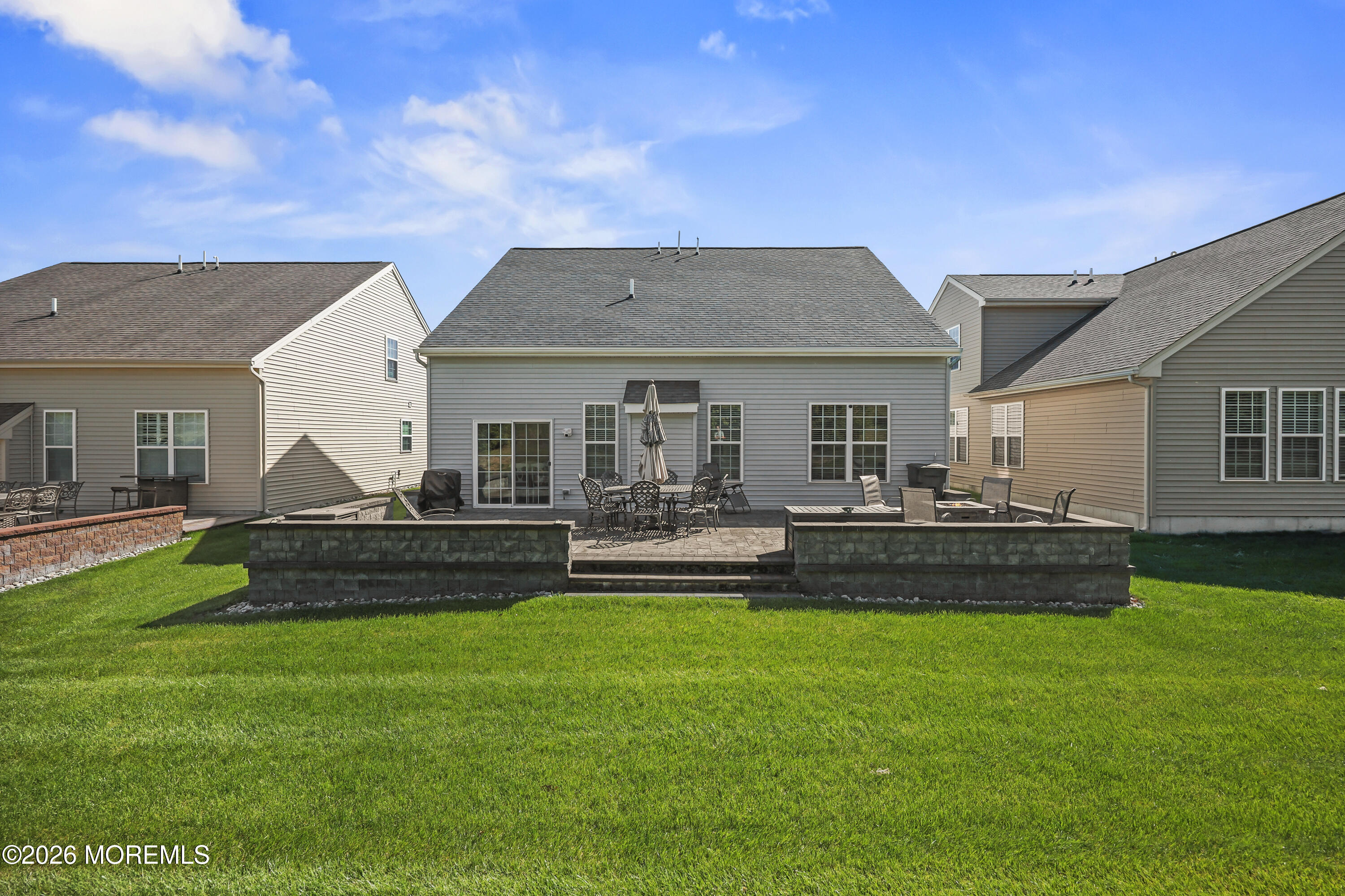 51 Mason Drive Jackson, NJ 08527 - Photo 26 of 39 a front view of a house with a garden and patio