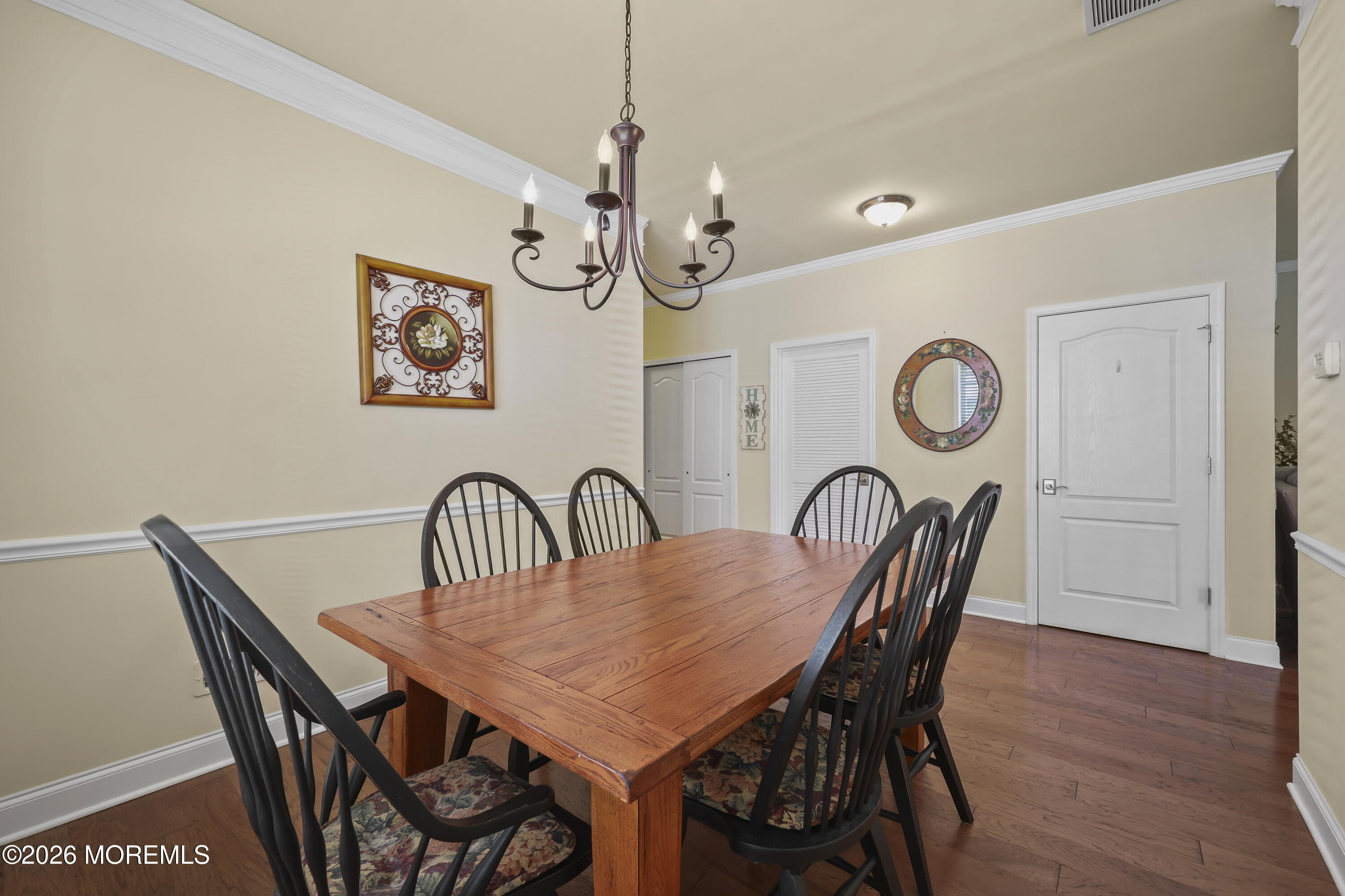 51 Mason Drive Jackson, NJ 08527 - Photo 8 of 39 a view of a dining room and livingroom with furniture a chandelier and wooden floor