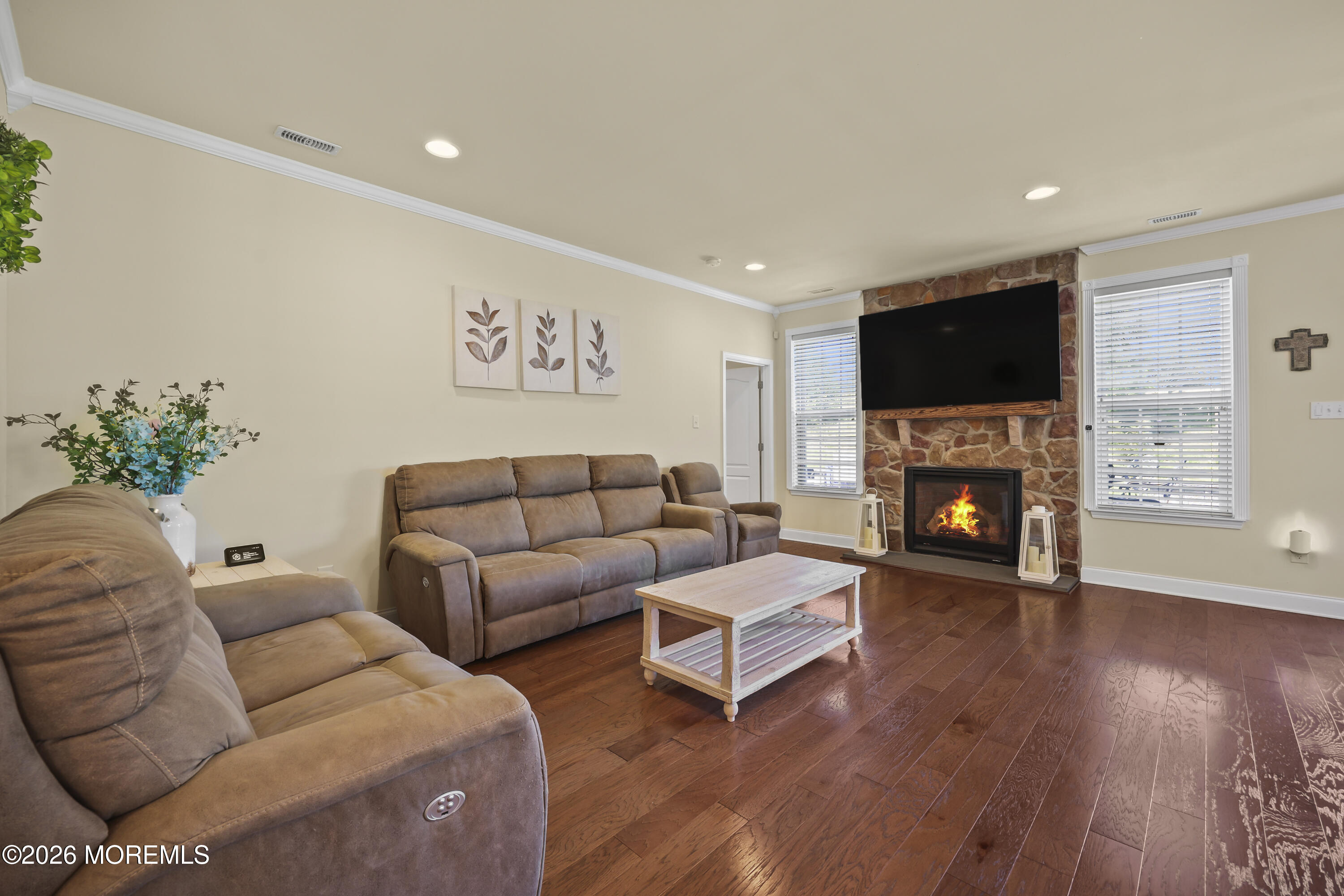 51 Mason Drive Jackson, NJ 08527 - Photo 9 of 39 a living room with furniture a flat screen tv and a fireplace