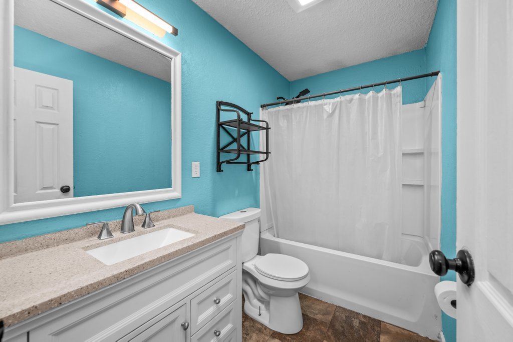 1500 9th Street Northwest Clinton, IA 52732 - Photo 12 of 28 a bathroom with a granite countertop sink toilet and shower