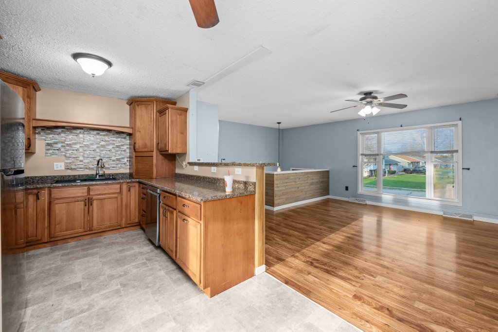 1500 9th Street Northwest Clinton, IA 52732 - Photo 15 of 28 a kitchen with stainless steel appliances granite countertop a sink and cabinets