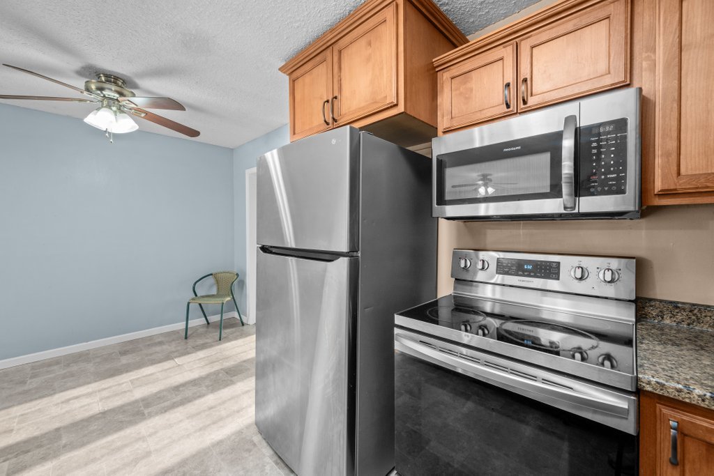 1500 9th Street Northwest Clinton, IA 52732 - Photo 17 of 28 a kitchen with stainless steel appliances granite countertop a refrigerator a stove and a sink
