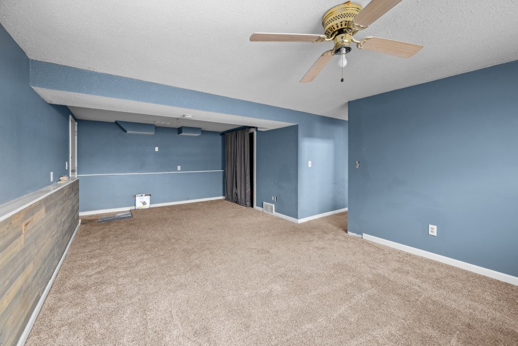 1500 9th Street Northwest Clinton, IA 52732 - Photo 21 of 28 a view of a big room with a ceiling fan and entryway
