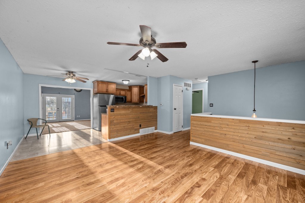 1500 9th Street Northwest Clinton, IA 52732 - Photo 7 of 28 a view of a room with wooden floor and ceiling fan