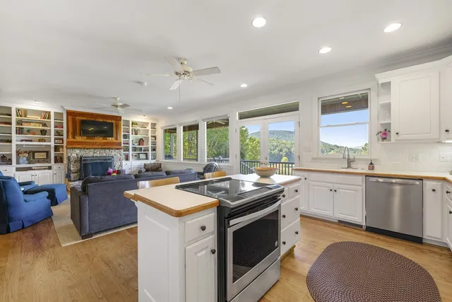 a view of a chairs and table in patio with wooden floor