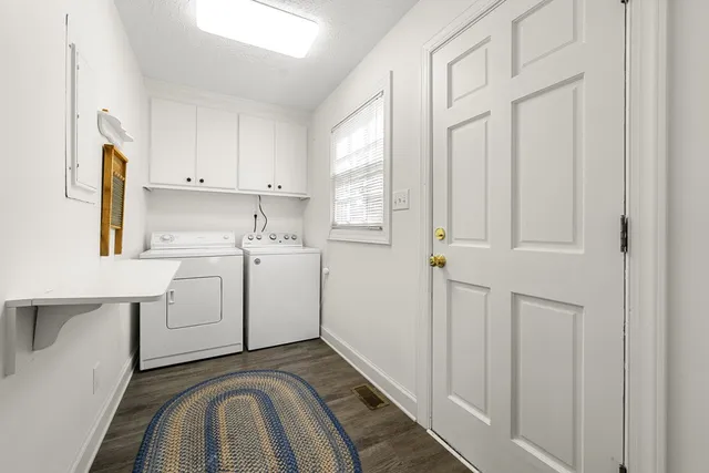 a bathroom with a granite countertop sink a mirror and a window