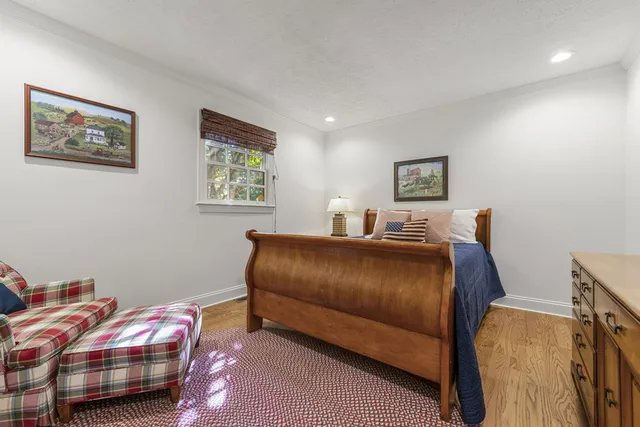 a bedroom with a large bed and a window