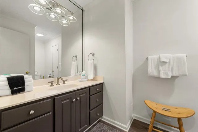 a view of a house with a deck and a large window with wooden floor