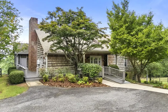 a front view of a house with a garden