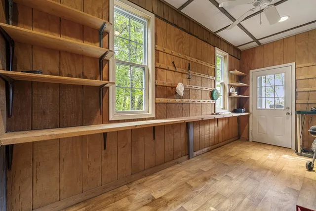 a view of a house with pool and chairs