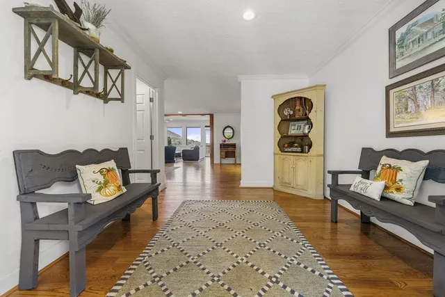 a living room with furniture a fireplace and a chandelier