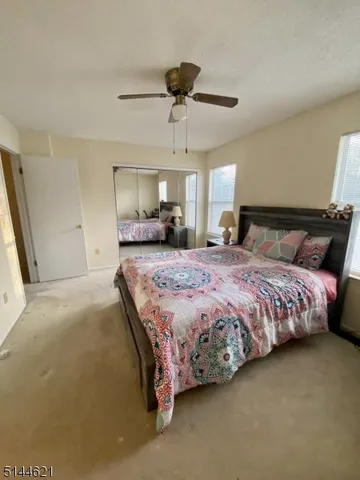 a bedroom with a large bed and a chandelier