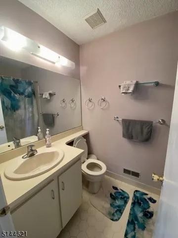 a bathroom with a sink toilet and a mirror