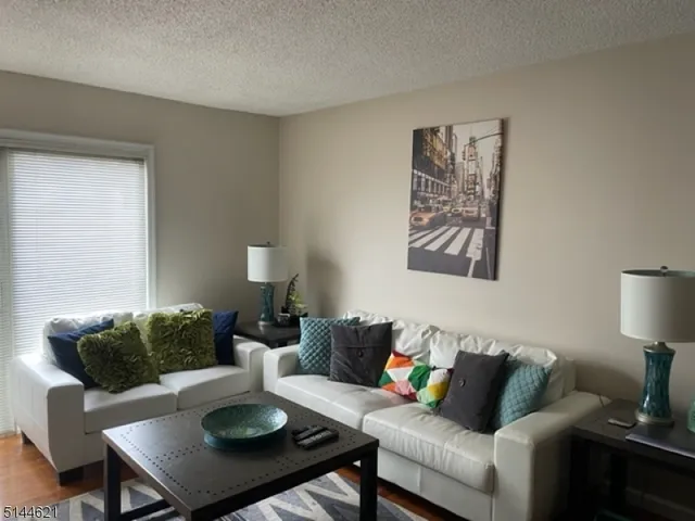 a living room with furniture and a lamp