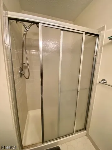 a bathroom with a glass shower door
