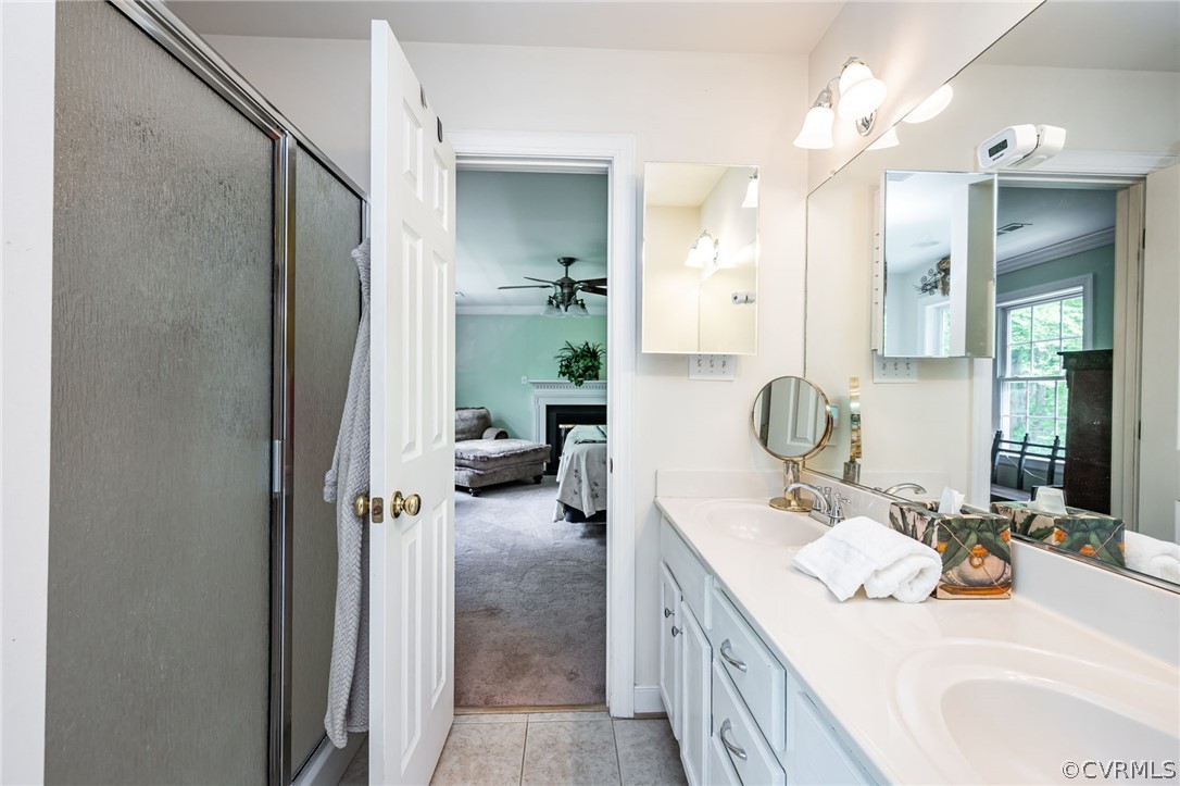 4501 Lakeview Road Gum Spring, VA 23065 - Photo 26 of 45 a en suite bathroom with a double vanity sink a mirror and shower
