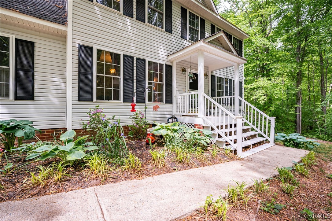 4501 Lakeview Road Gum Spring, VA 23065 - Photo 3 of 45 a front view of a house with a garden