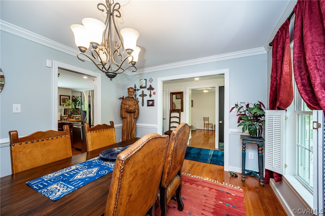 4501 Lakeview Road Gum Spring, VA 23065 - Photo 8 of 45 a view of a dining room with furniture and a chandelier