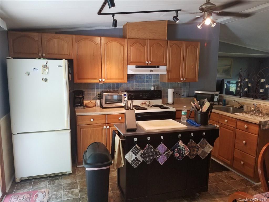 433 Abel Road Canton, NC 28716 - Photo 11 of 18 a kitchen with stainless steel appliances granite countertop a refrigerator a stove a sink dishwasher and a microwave with wooden floor