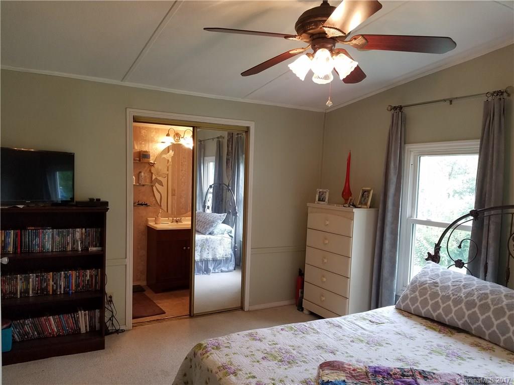433 Abel Road Canton, NC 28716 - Photo 14 of 18 a bedroom with a bed and a television