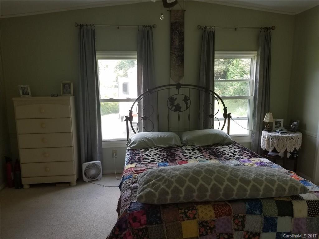 433 Abel Road Canton, NC 28716 - Photo 16 of 18 a bedroom with a bed and a dresser