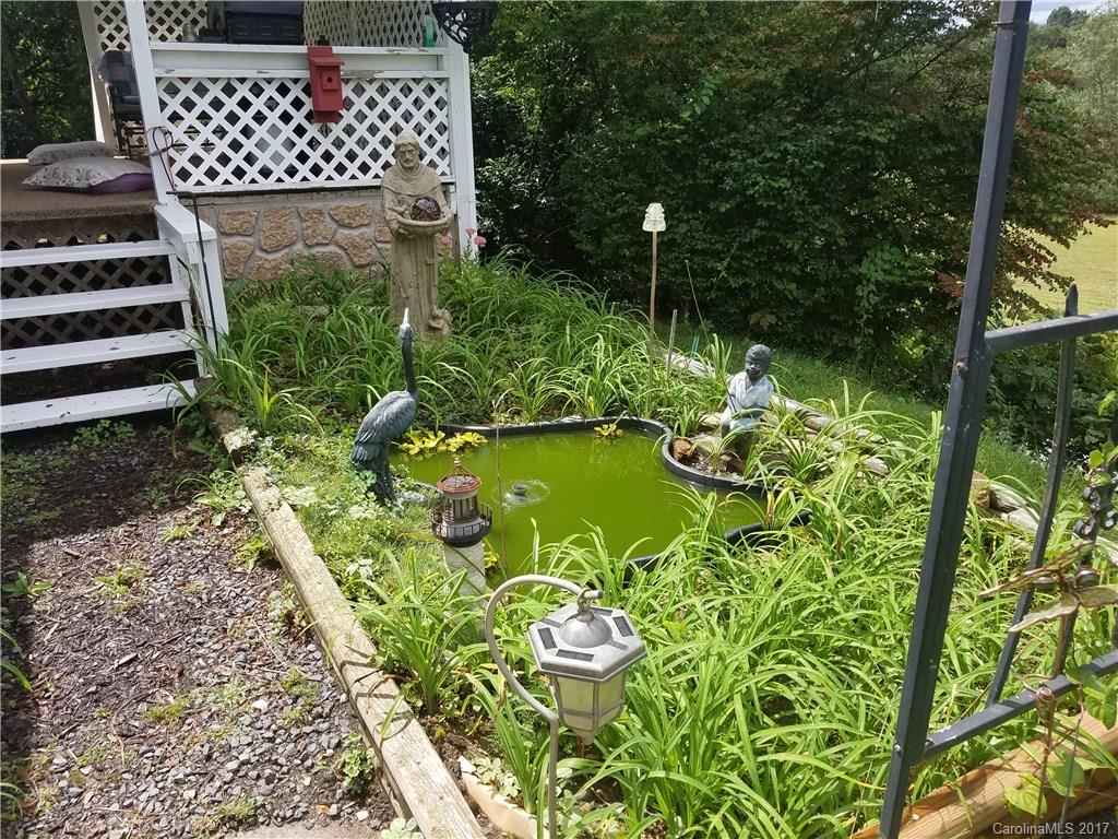 433 Abel Road Canton, NC 28716 - Photo 5 of 18 a view of a garden with a bench