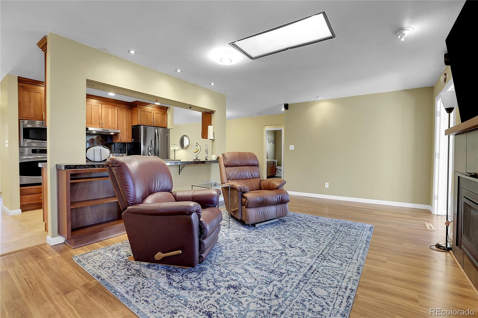 7539 East Easter Place Centennial, CO 80112 - Photo 14 of 40 a living room with furniture rug and wooden floor