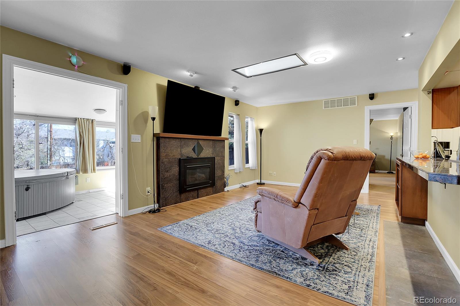 7539 East Easter Place Centennial, CO 80112 - Photo 15 of 40 a living room with furniture and a flat screen tv