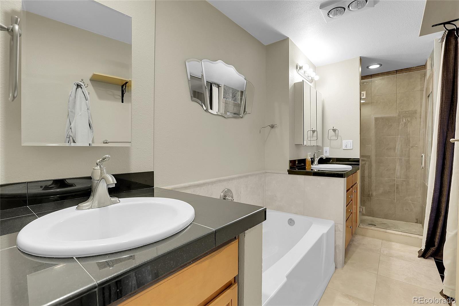 7539 East Easter Place Centennial, CO 80112 - Photo 21 of 40 a bathroom with a sink and a mirror