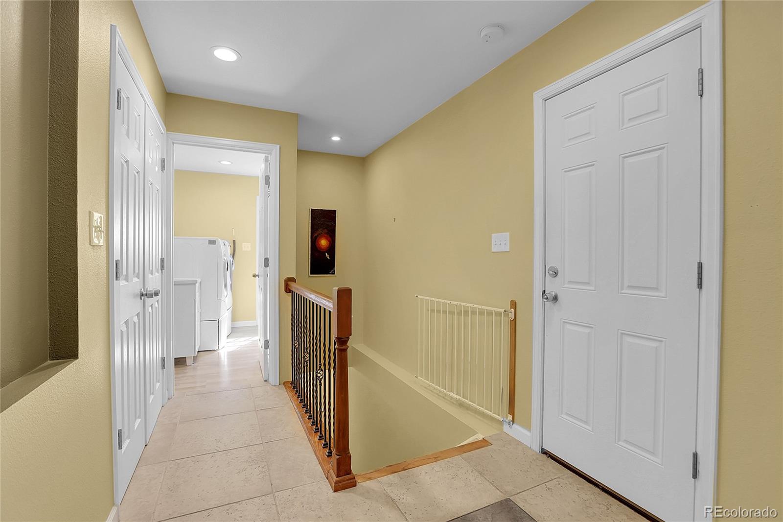 7539 East Easter Place Centennial, CO 80112 - Photo 28 of 40 a view of a hallway with a furniture and front door
