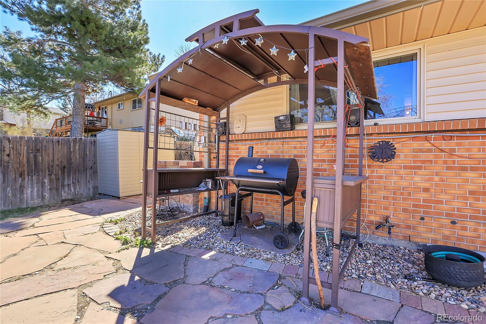 7539 East Easter Place Centennial, CO 80112 - Photo 34 of 40 a view of a chairs and table in the backyard