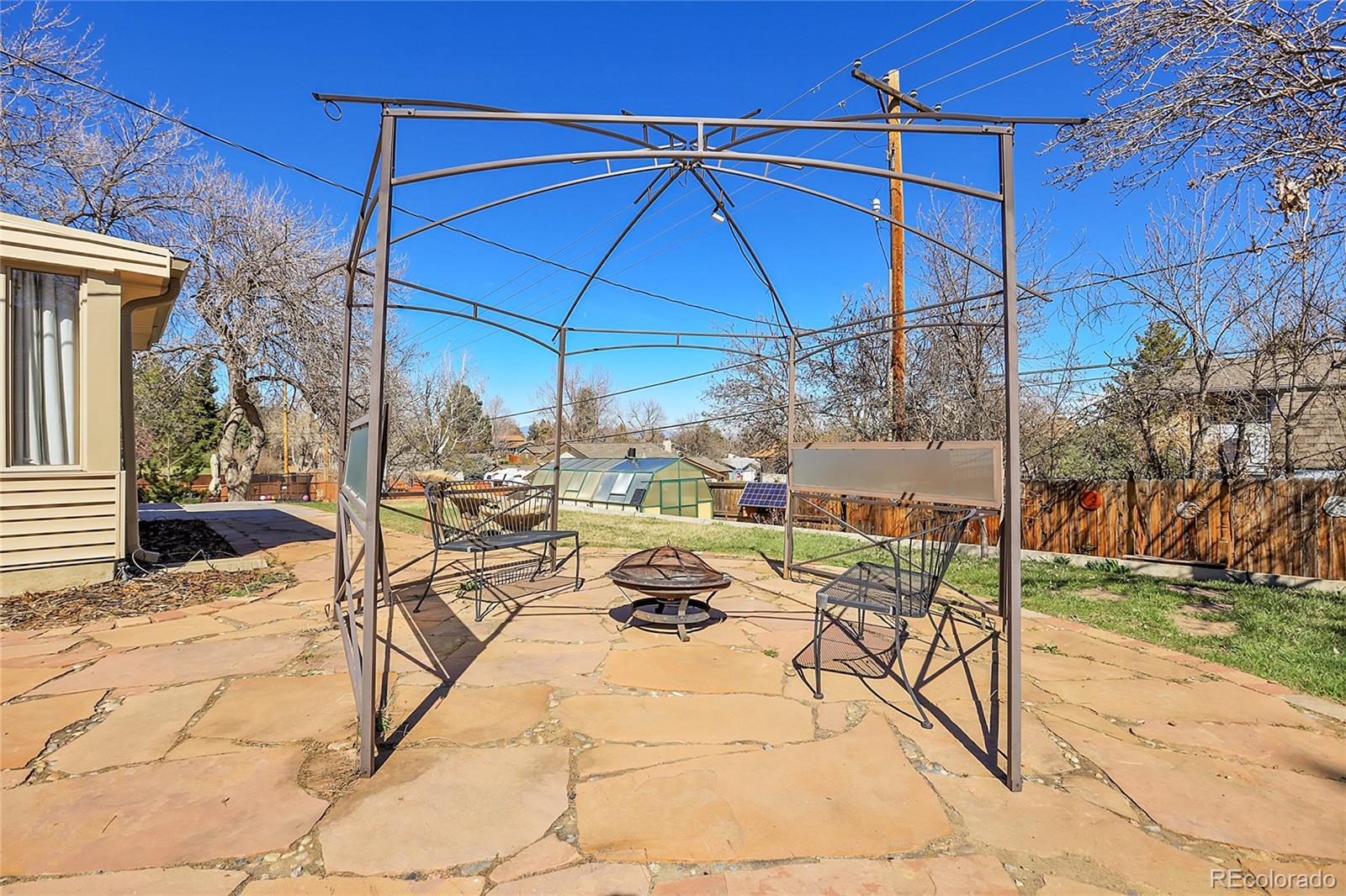 7539 East Easter Place Centennial, CO 80112 - Photo 35 of 40 a view of a patio with a table and chairs under an umbrella