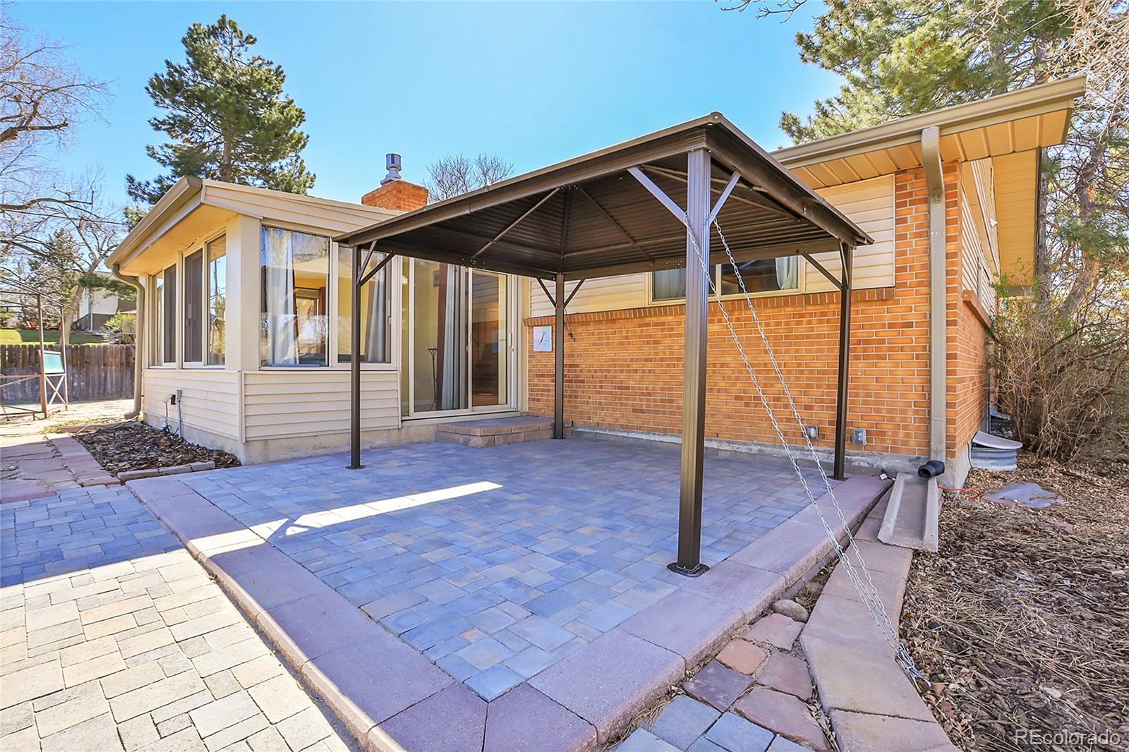 7539 East Easter Place Centennial, CO 80112 - Photo 36 of 40 a front view of a house with a yard