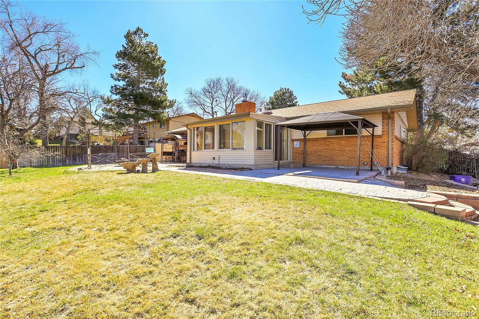 7539 East Easter Place Centennial, CO 80112 - Photo 39 of 40 a view of a house with a yard patio and swimming pool