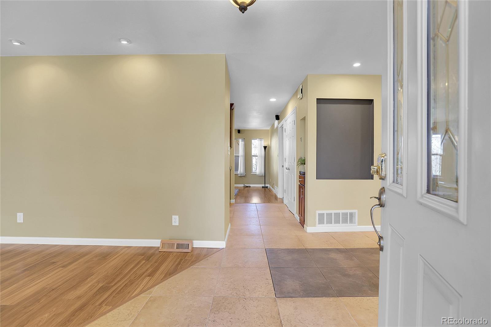 7539 East Easter Place Centennial, CO 80112 - Photo 4 of 40 an empty room with wooden floor and windows