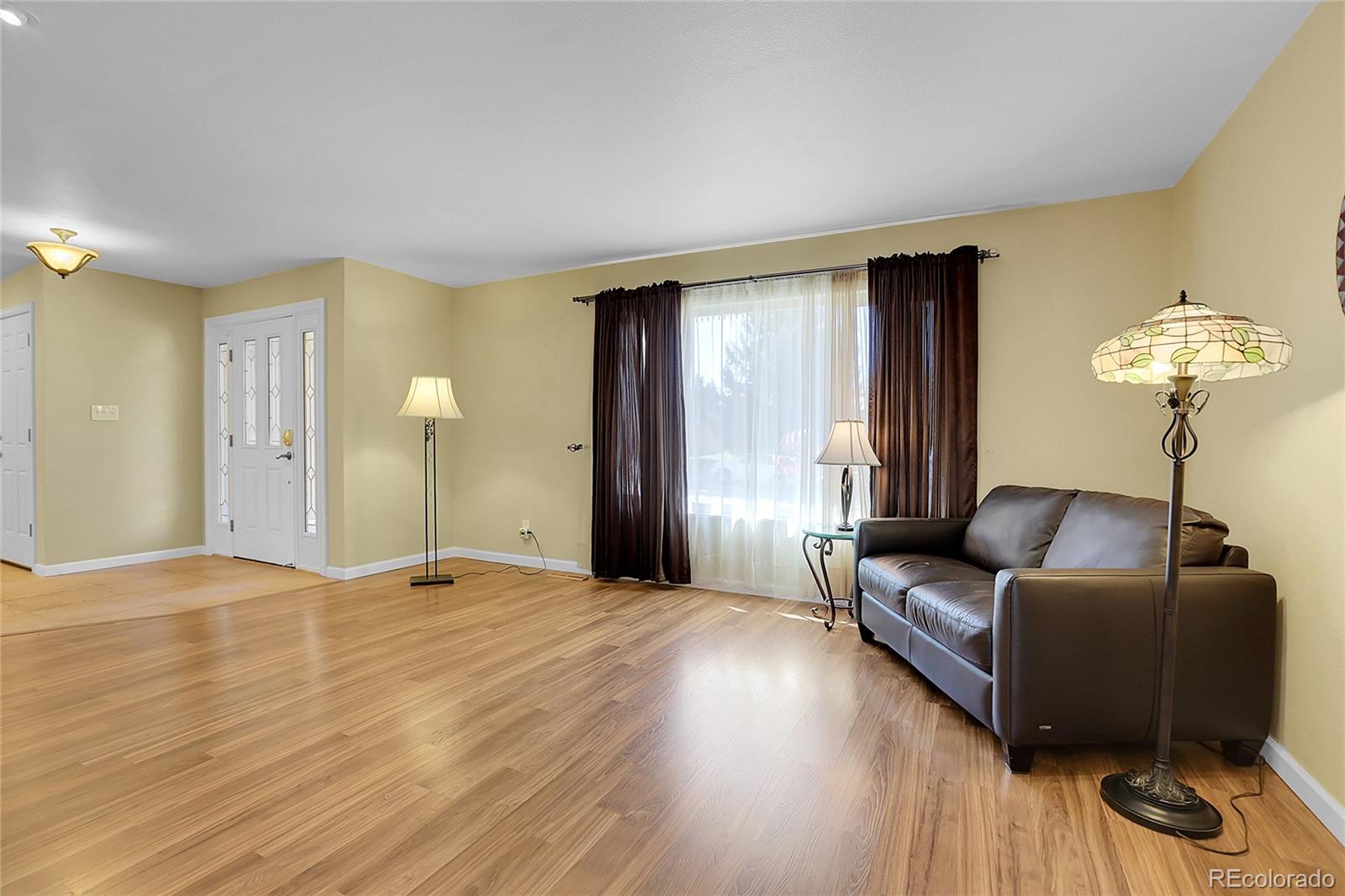 7539 East Easter Place Centennial, CO 80112 - Photo 6 of 40 a living room with furniture and a chandelier
