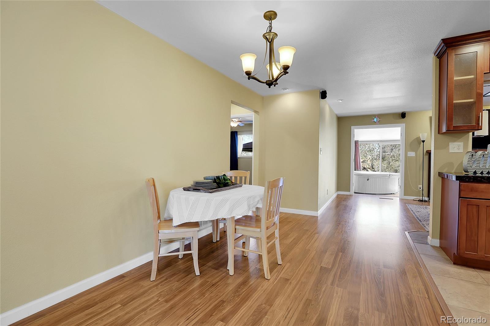 7539 East Easter Place Centennial, CO 80112 - Photo 7 of 40 a view of a dining room with furniture and wooden floor