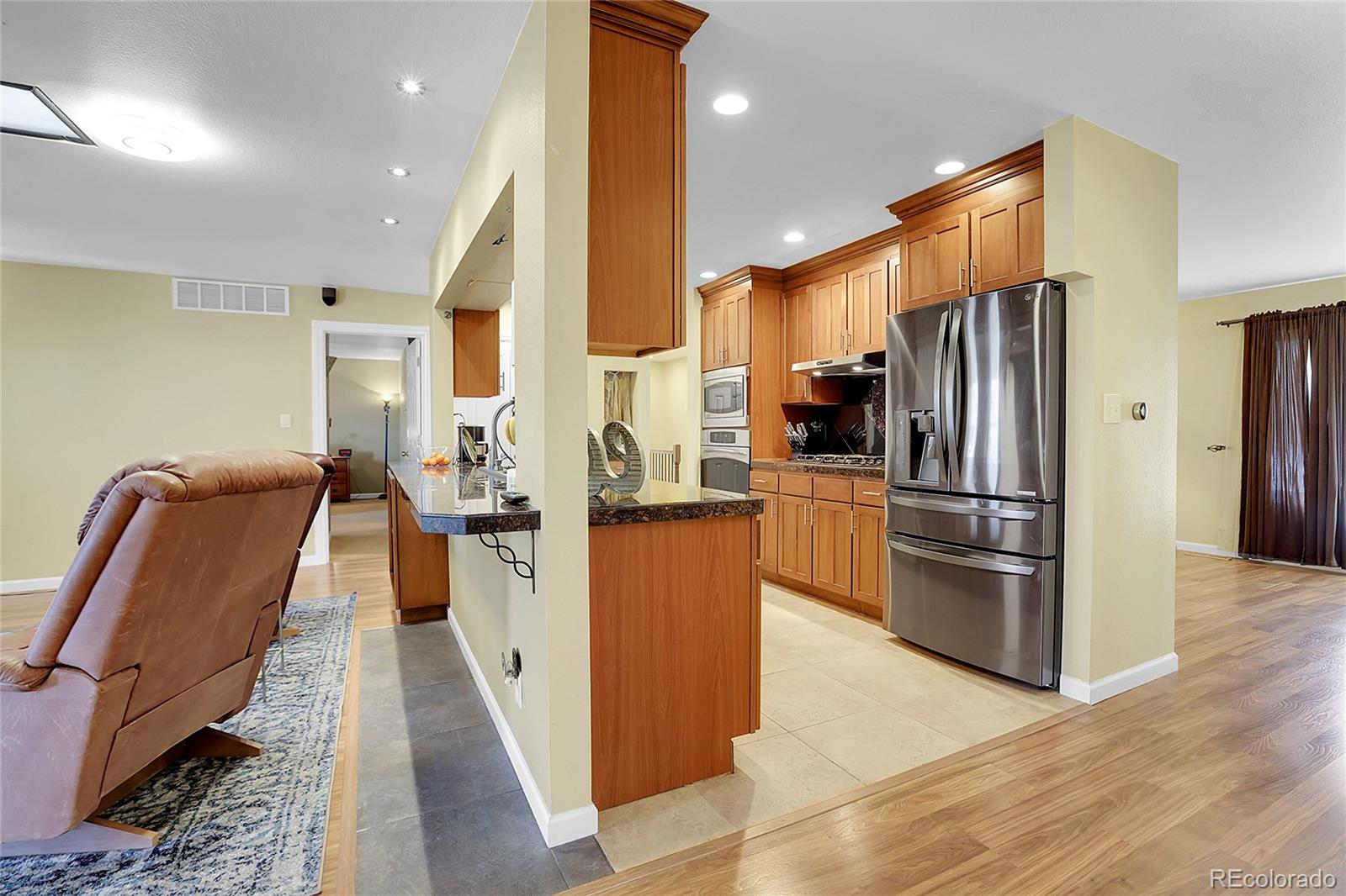 7539 East Easter Place Centennial, CO 80112 - Photo 9 of 40 a kitchen with stainless steel appliances granite countertop a refrigerator a stove top oven and sink