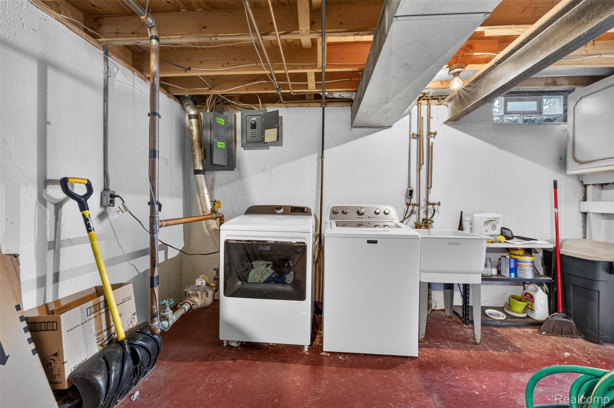 1439 Oakbrook E Drive Rochester, MI 48307 - Photo 45 of 68 Laundry area with a utility sink, exposed ceiling joists, and a painted concrete floor